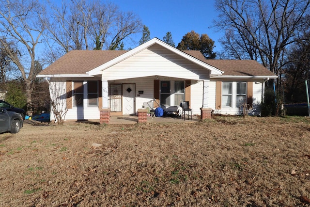 ranch-style house featuring a front yard and a porch