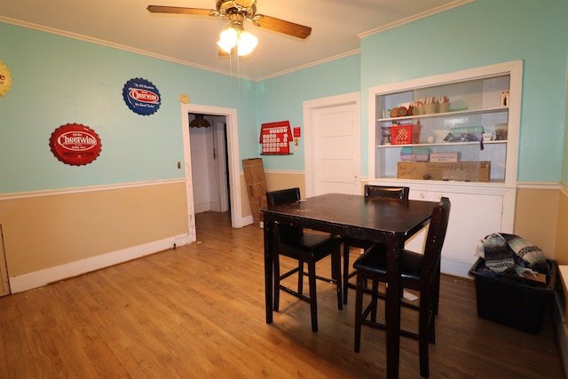 dining space with crown molding, hardwood / wood-style floors, and ceiling fan