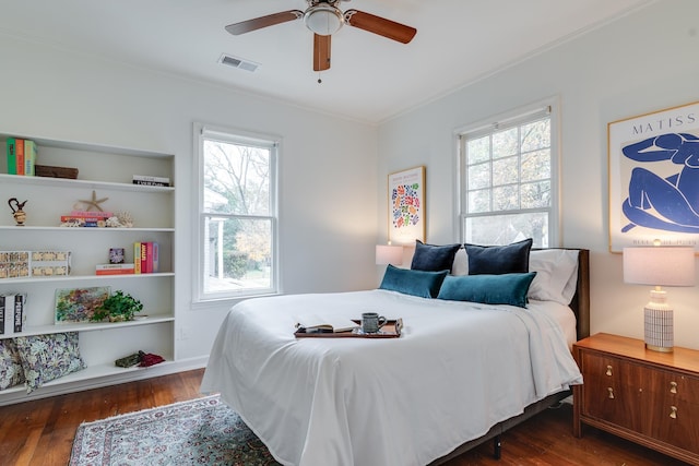 bedroom featuring ceiling fan, dark hardwood / wood-style floors, crown molding, and multiple windows