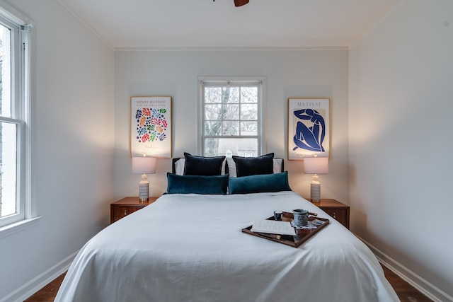 bedroom featuring ceiling fan, hardwood / wood-style floors, and ornamental molding