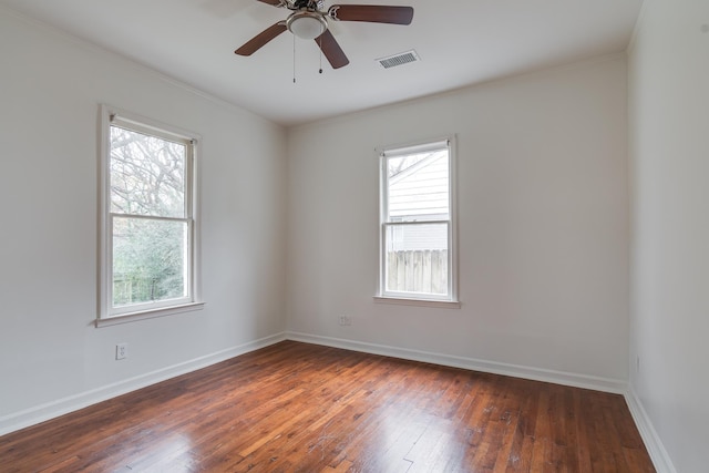 spare room featuring ceiling fan and dark wood-type flooring