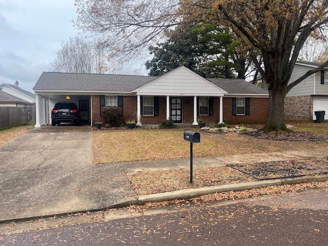 view of front of home featuring covered porch and a carport