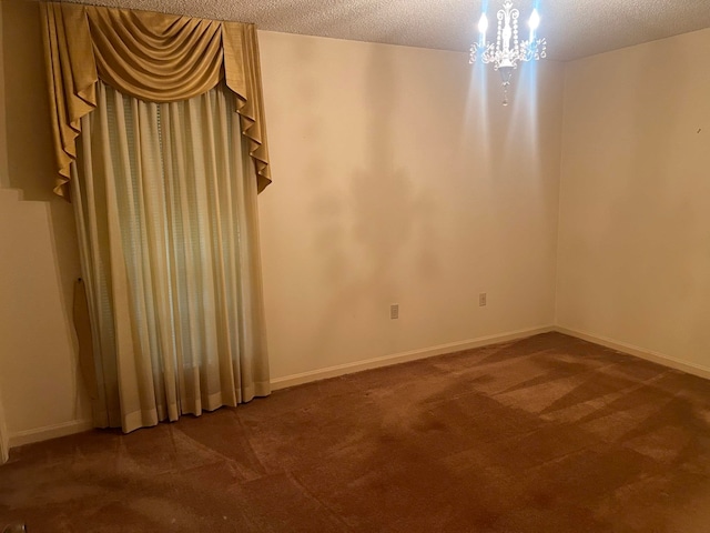 carpeted spare room featuring a textured ceiling