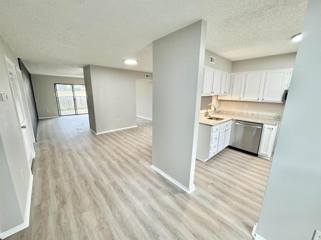 kitchen with stainless steel dishwasher, a textured ceiling, sink, light hardwood / wood-style flooring, and white cabinets