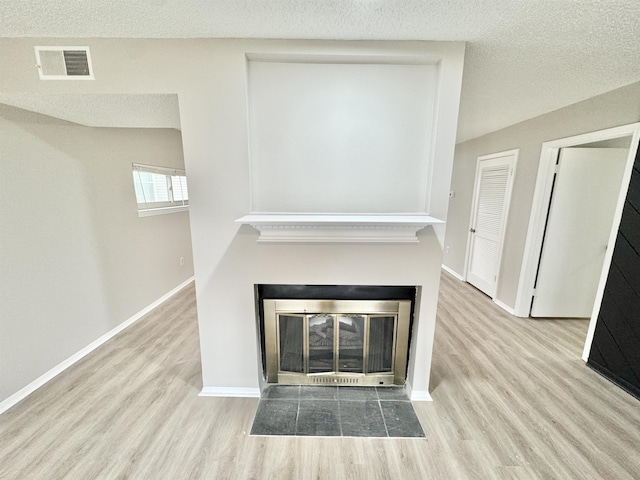 interior details featuring wood-type flooring and a textured ceiling