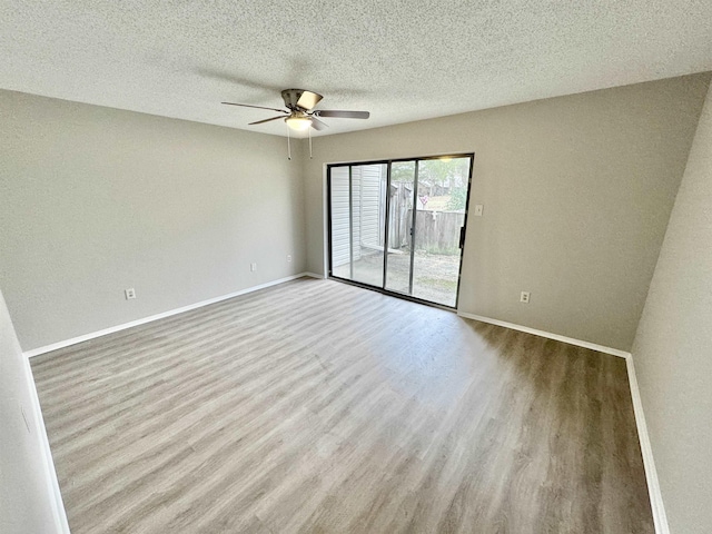 empty room with ceiling fan, light hardwood / wood-style floors, and a textured ceiling