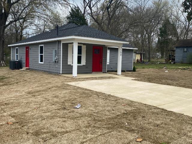 view of front of house with central AC unit and a garage