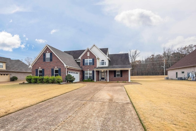 view of front of home with covered porch, a garage, and a front yard