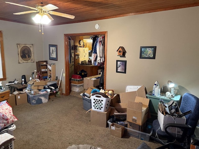 interior space featuring carpet floors, ceiling fan, and wood ceiling