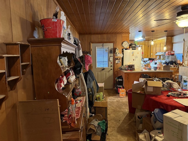 misc room with wooden walls, ceiling fan, and wood ceiling