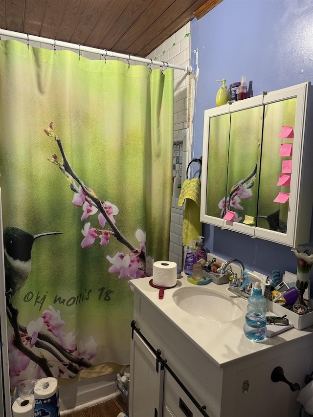 bathroom with curtained shower, vanity, and wooden ceiling