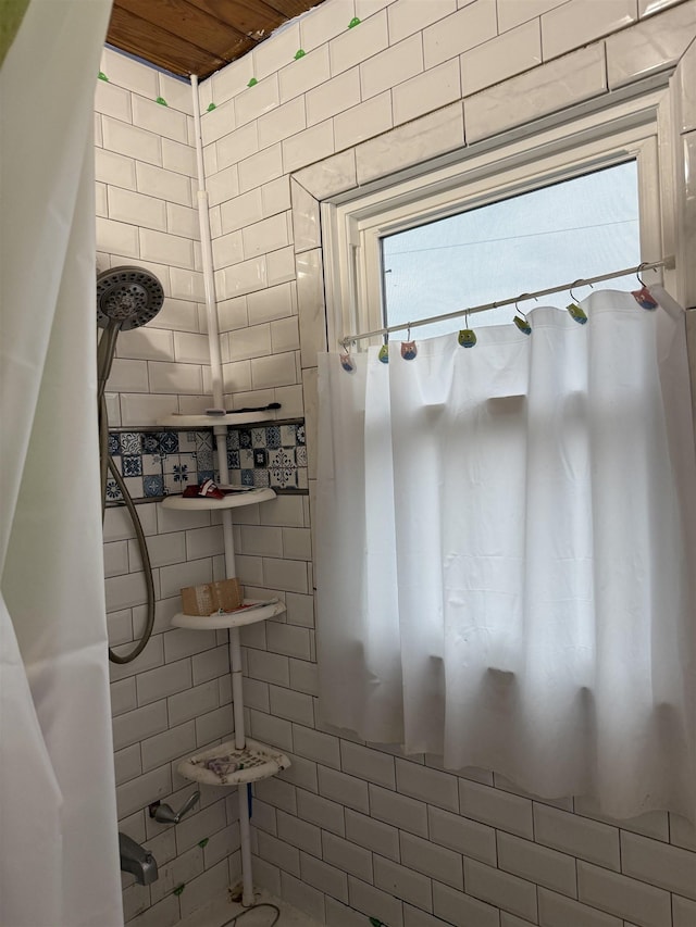 bathroom with tiled shower