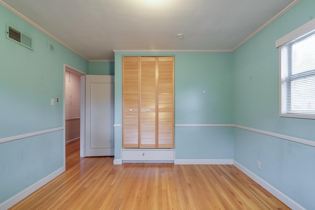 unfurnished bedroom with crown molding and light hardwood / wood-style flooring