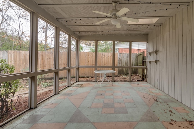 unfurnished sunroom with plenty of natural light and ceiling fan