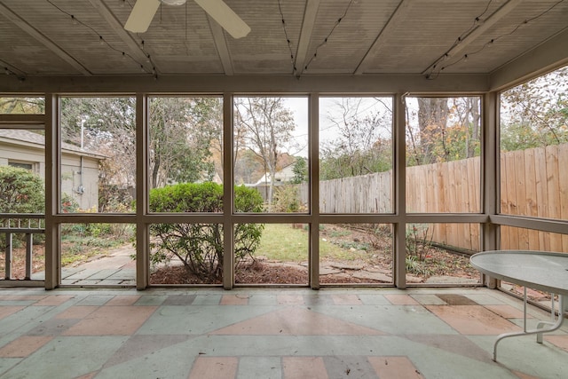 unfurnished sunroom featuring ceiling fan