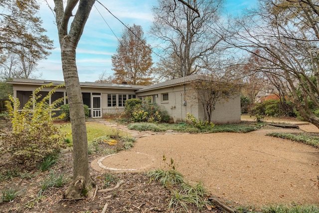 back of house featuring a sunroom