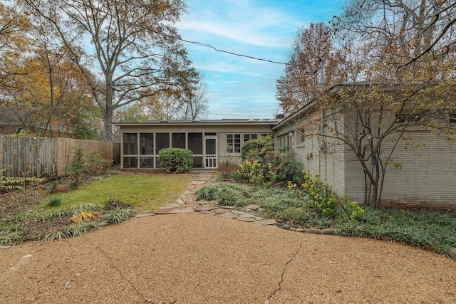 back of house featuring a sunroom