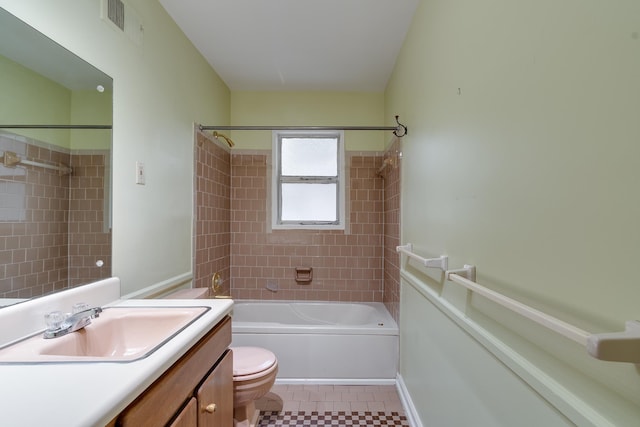 full bathroom with tile patterned flooring, vanity, toilet, and tiled shower / bath