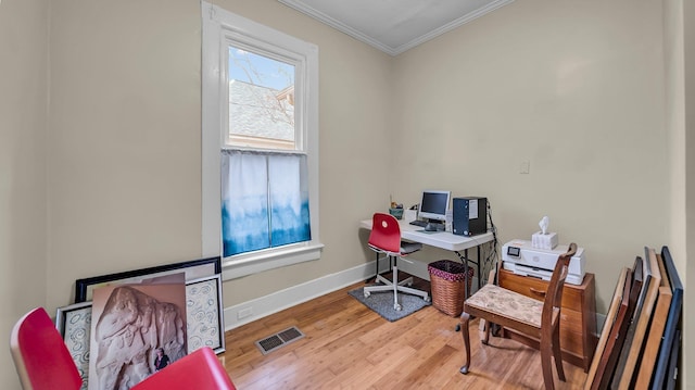 home office featuring hardwood / wood-style flooring and ornamental molding