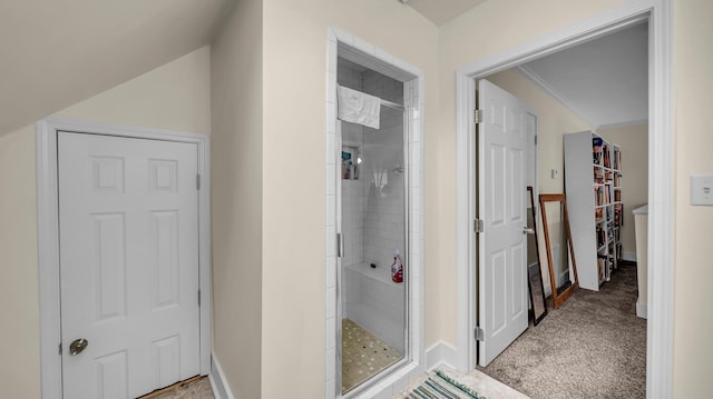 bathroom featuring a shower with shower door