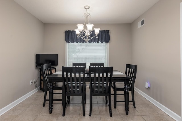 tiled dining area with a notable chandelier