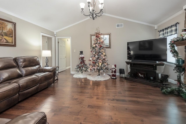 living room with dark hardwood / wood-style flooring, vaulted ceiling, ornamental molding, and a notable chandelier