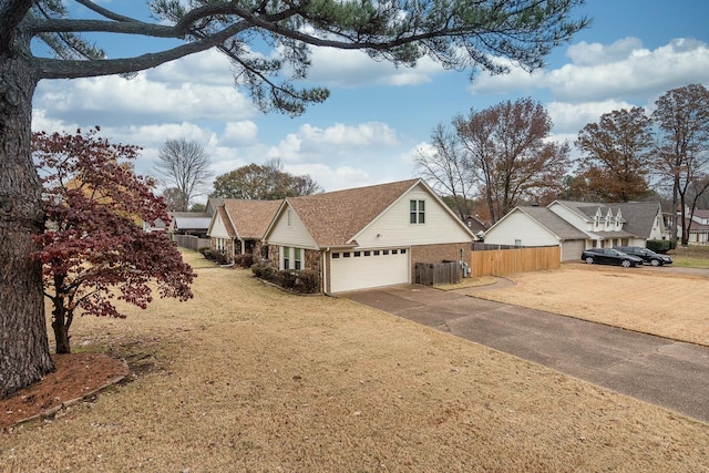 view of home's exterior featuring driveway, a yard, and fence