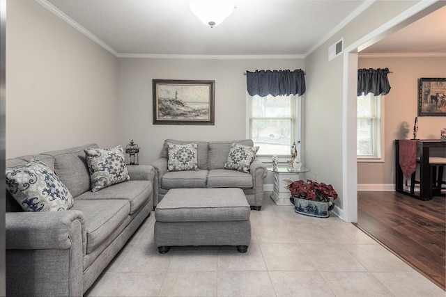 living room with light wood-type flooring, plenty of natural light, and crown molding