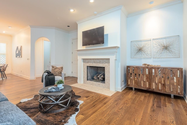 9207 Liggon Green Ln, Germantown, TN 38139 - living room with arched walkways, wood finished floors, ornamental molding, a fireplace with flush hearth, and recessed lighting