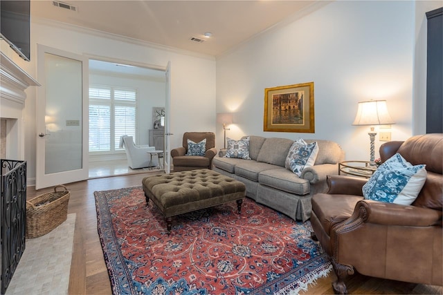 living room with hardwood / wood-style floors and ornamental molding