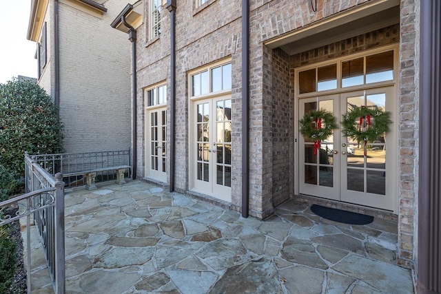 property entrance featuring french doors and a patio