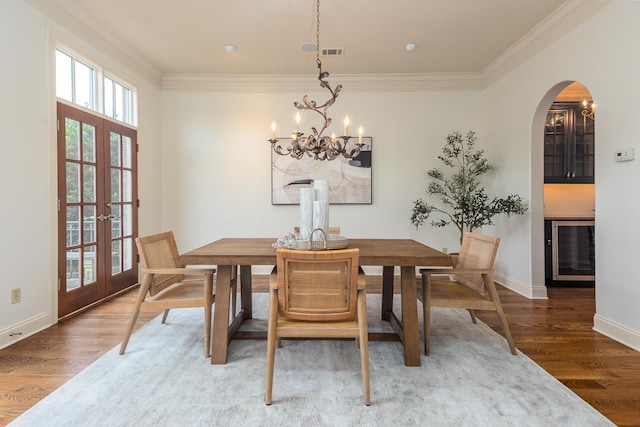 9207 Liggon Green Ln, Germantown, TN 38139 - dining area with wood finished floors, beverage cooler, healthy amount of natural light, a chandelier, and ornamental molding