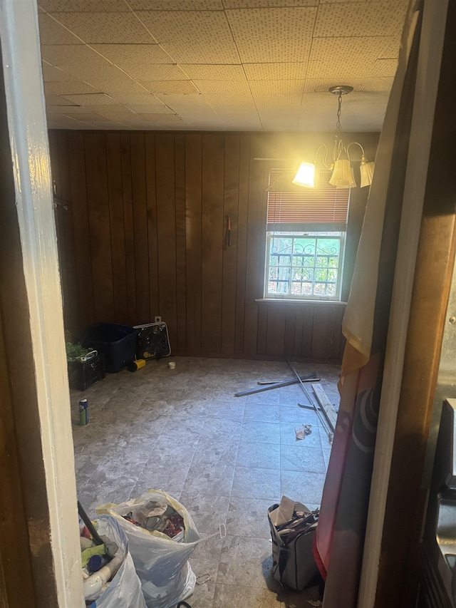 spare room featuring wooden walls