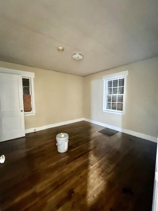 empty room with dark wood-type flooring