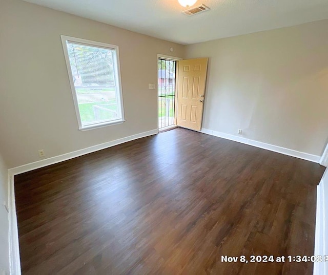 spare room featuring dark hardwood / wood-style floors