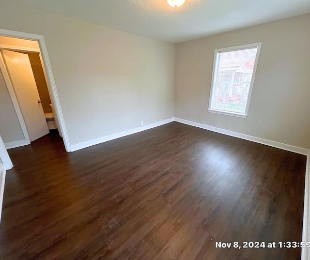 empty room with dark wood-type flooring