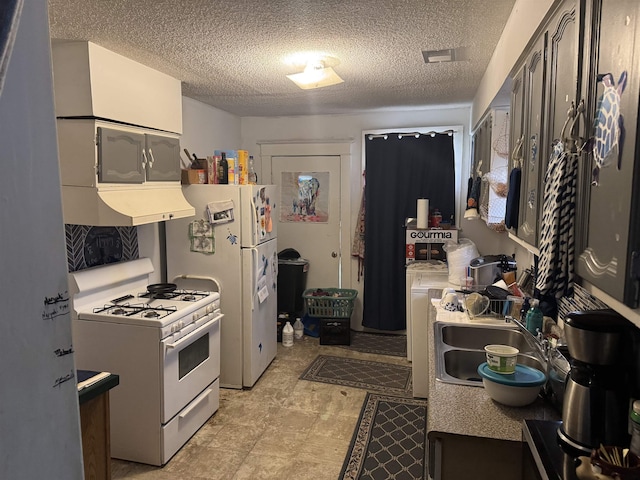 kitchen with a textured ceiling, white appliances, sink, and extractor fan