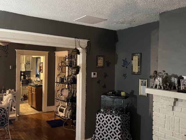 interior space featuring a textured ceiling and light wood-type flooring