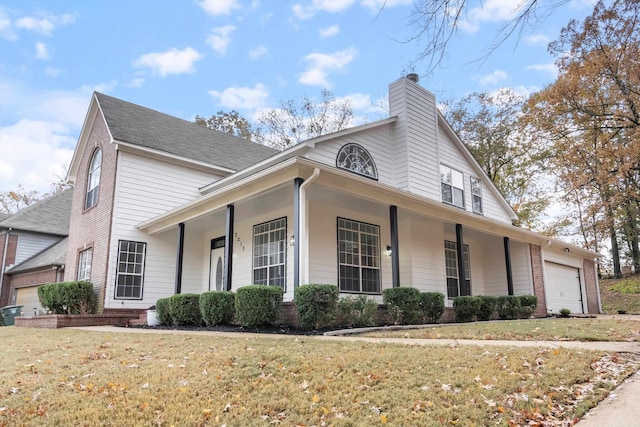 view of front of house featuring a porch, a garage, and a front lawn