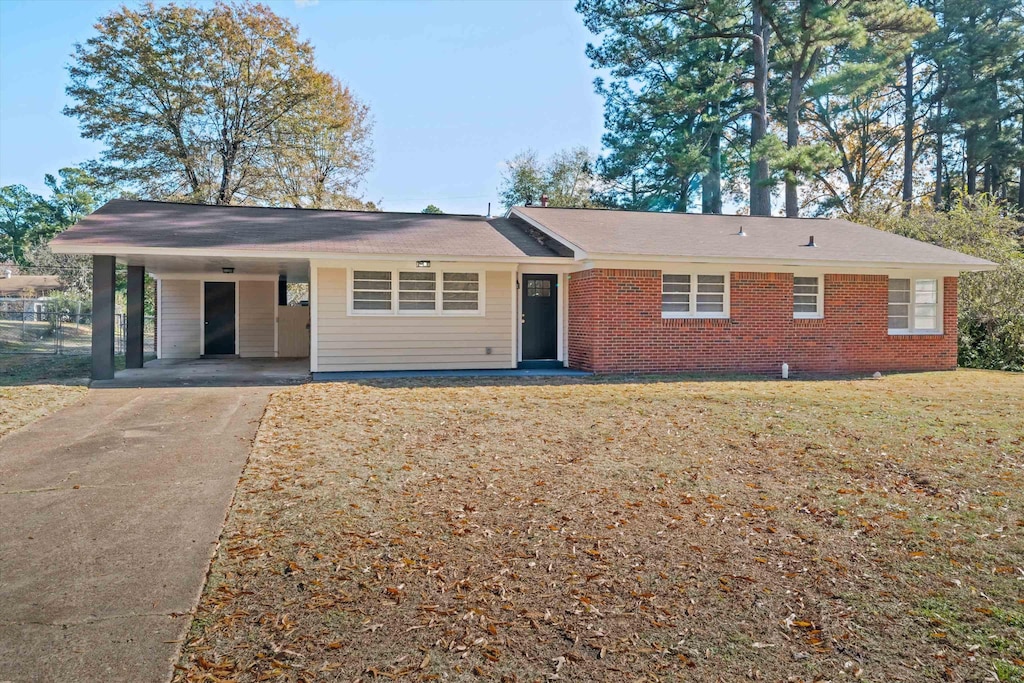 ranch-style home featuring a front yard and a carport