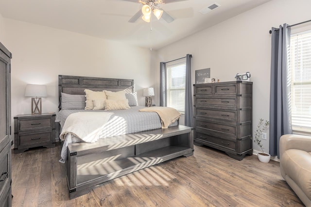 bedroom with ceiling fan and dark hardwood / wood-style floors