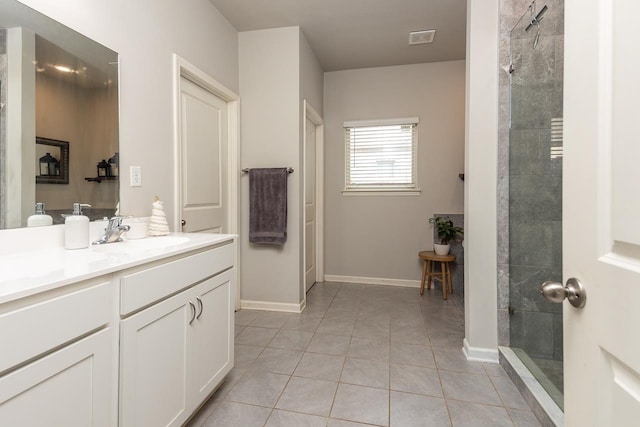 bathroom featuring vanity, tile patterned floors, and tiled shower