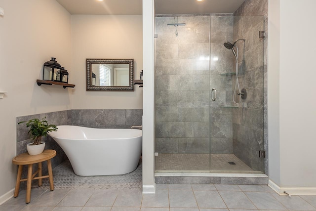 bathroom featuring tile patterned floors and shower with separate bathtub