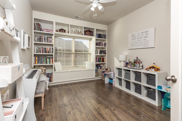 miscellaneous room with ceiling fan and dark hardwood / wood-style flooring