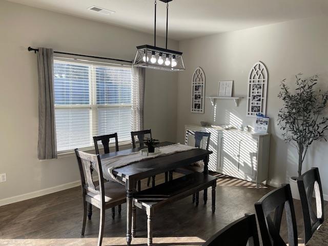 dining space with dark hardwood / wood-style flooring