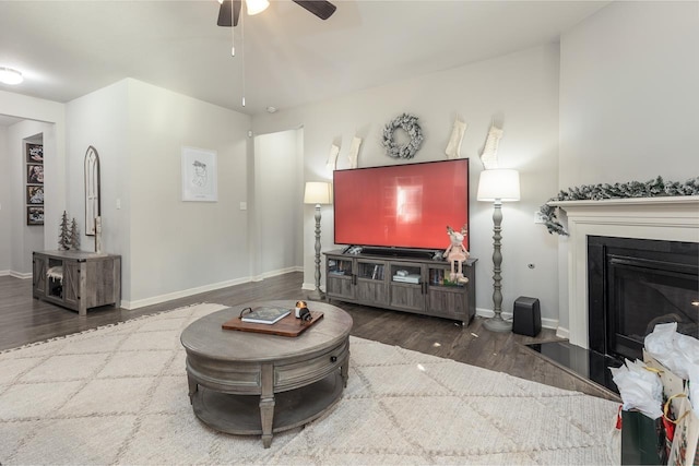 living room with ceiling fan and dark hardwood / wood-style flooring