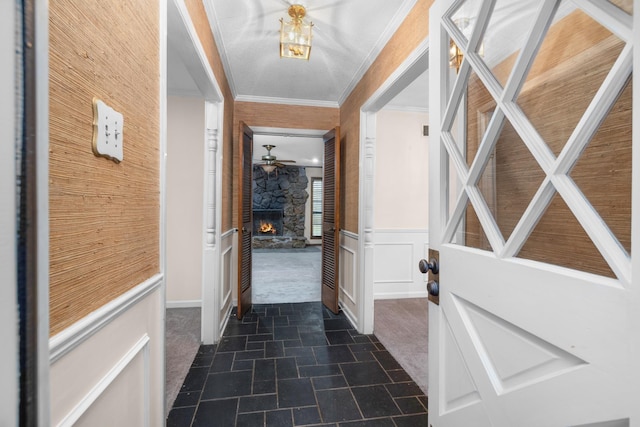 interior space with dark colored carpet and ornamental molding