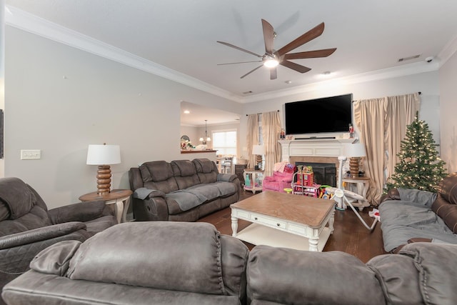 living room featuring ceiling fan, dark hardwood / wood-style flooring, and crown molding