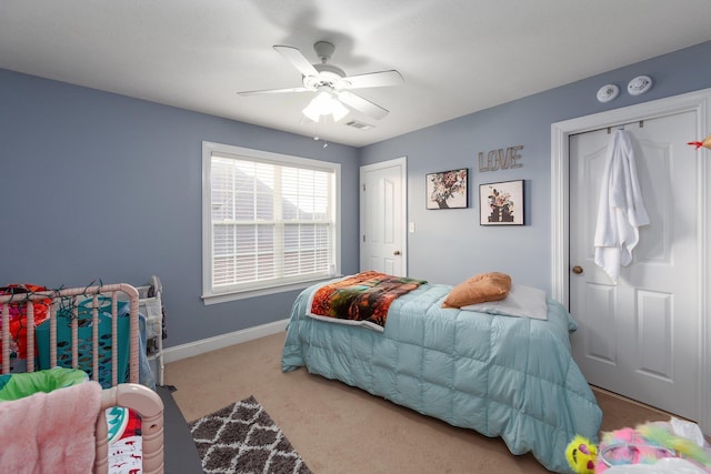 bedroom featuring light colored carpet and ceiling fan