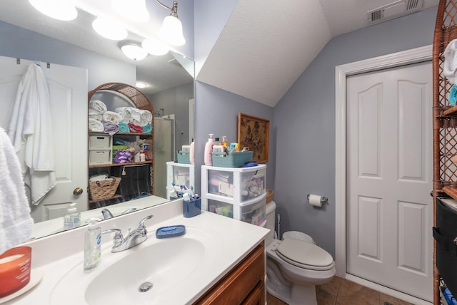 bathroom featuring an enclosed shower, a textured ceiling, vaulted ceiling, tile patterned flooring, and toilet